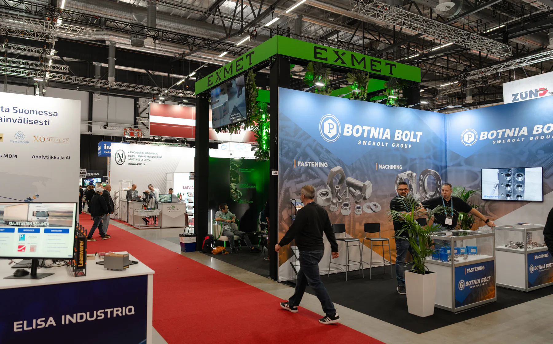 Exmet stand with its green EXMET frame seen across the exhibition hall