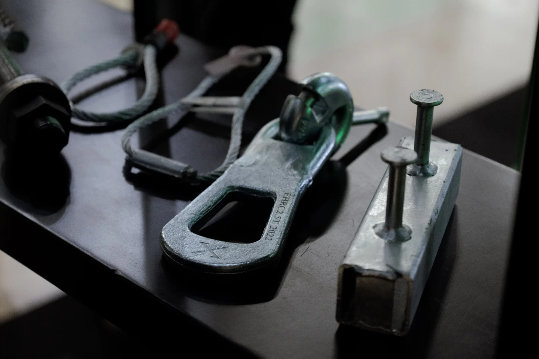 Finished metal components on a dark surface