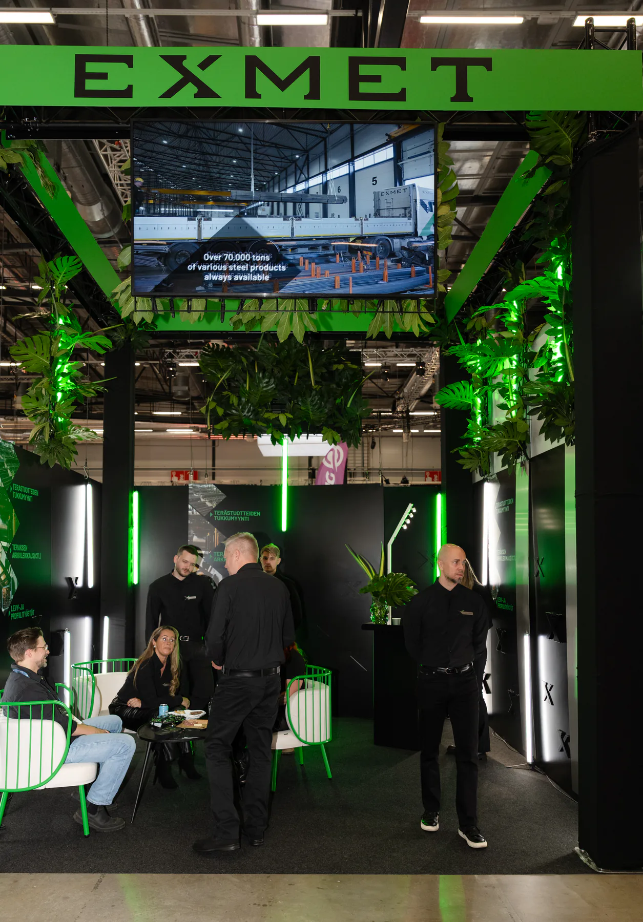 Front of the Exmet stand with screen and visitors inside