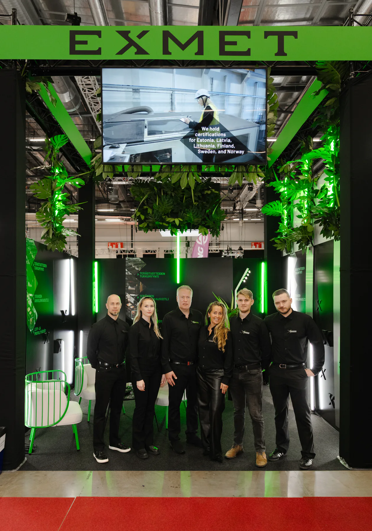 Exmet team standing together inside the stand