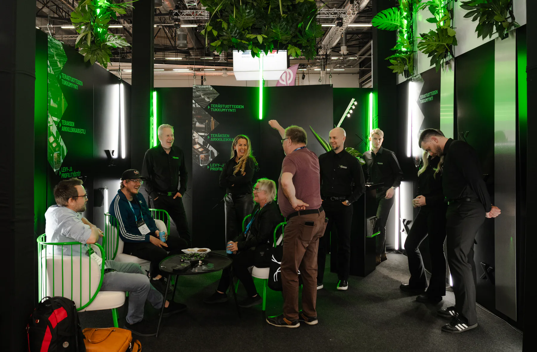 Group of visitors and Exmet team members inside the stand