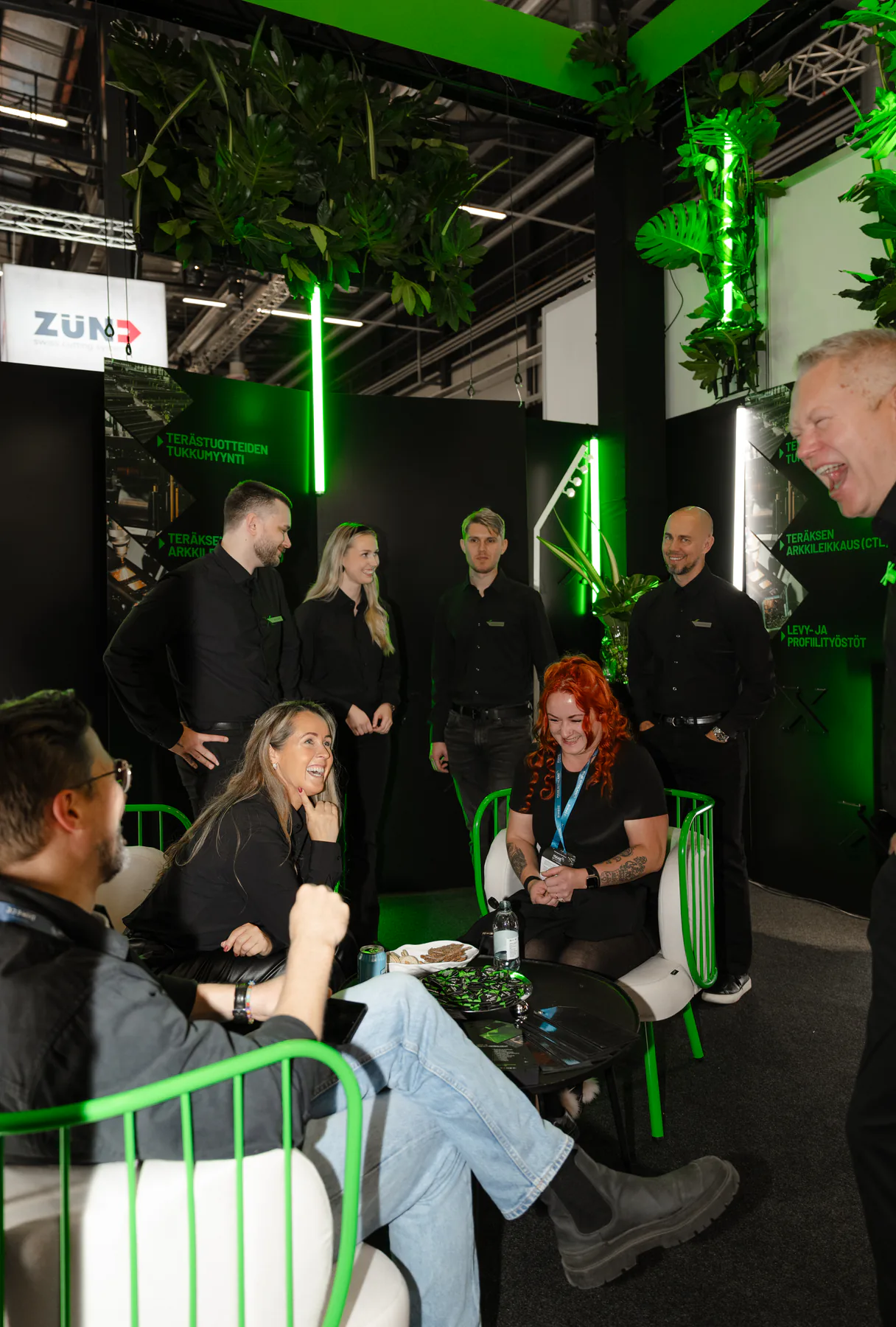Visitors and Exmet team members talking inside the stand