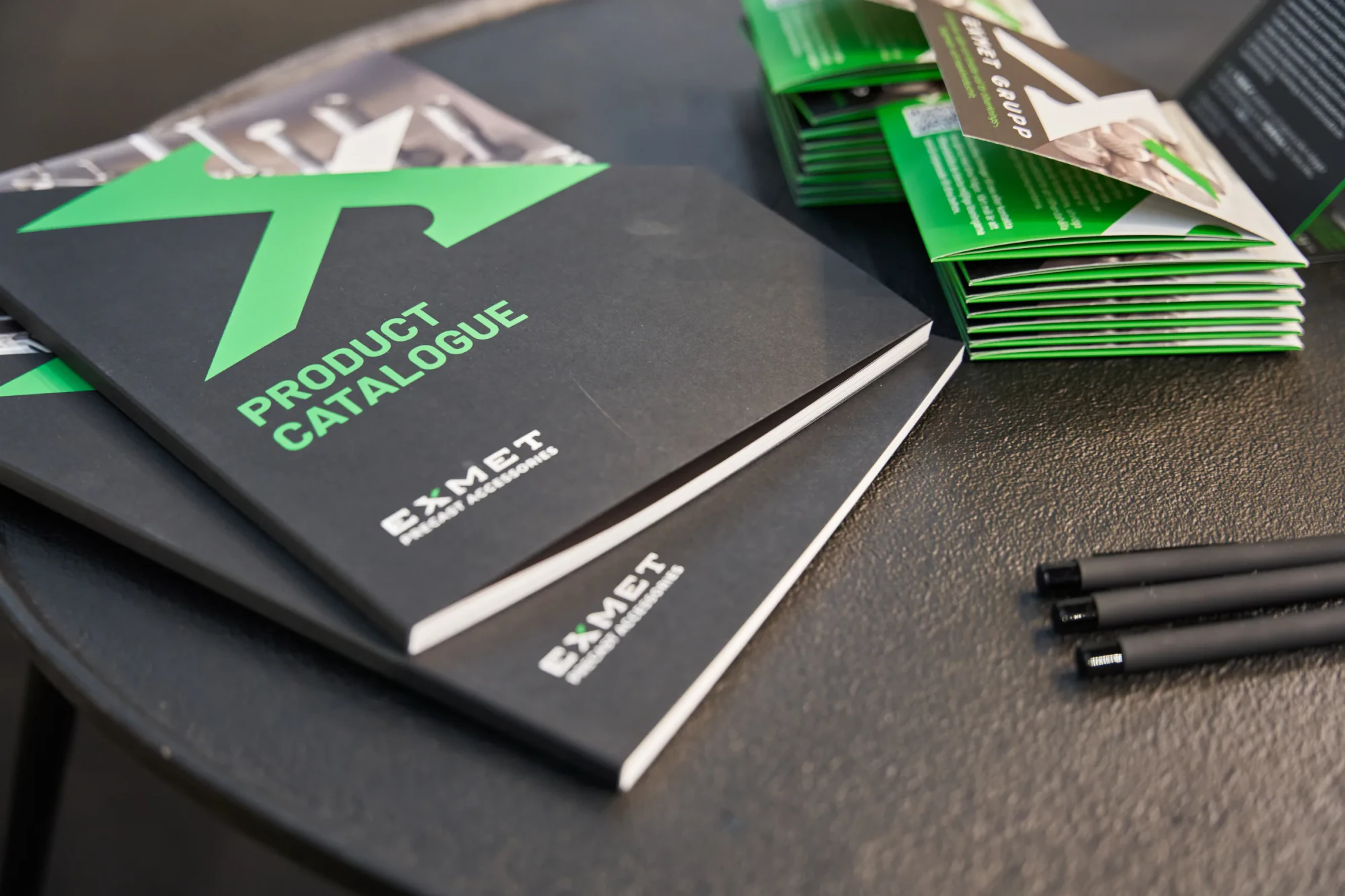 Exmet-branded steel materials arranged on a dark tray