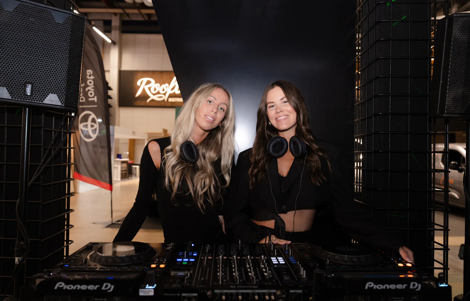 Two DJs at the decks during the client evening