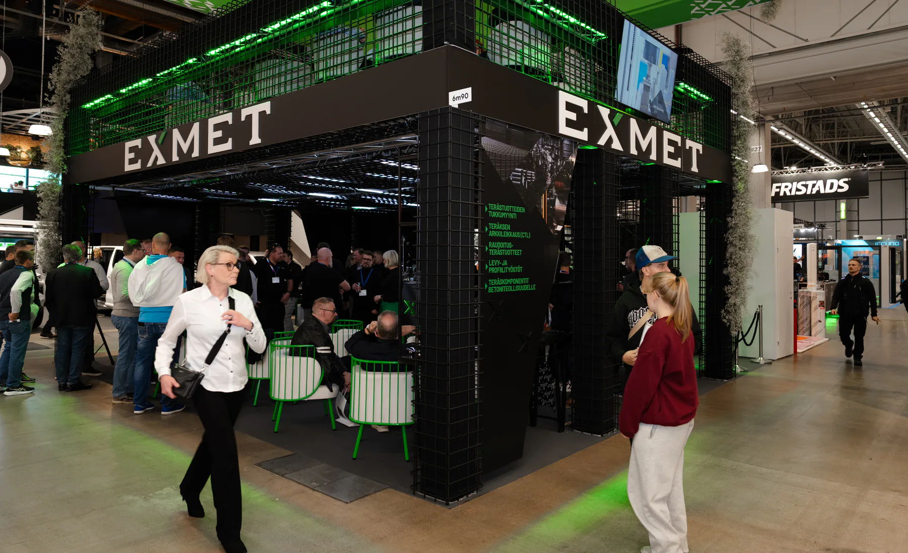 Busy Exmet stand seen from the aisle with visitors inside