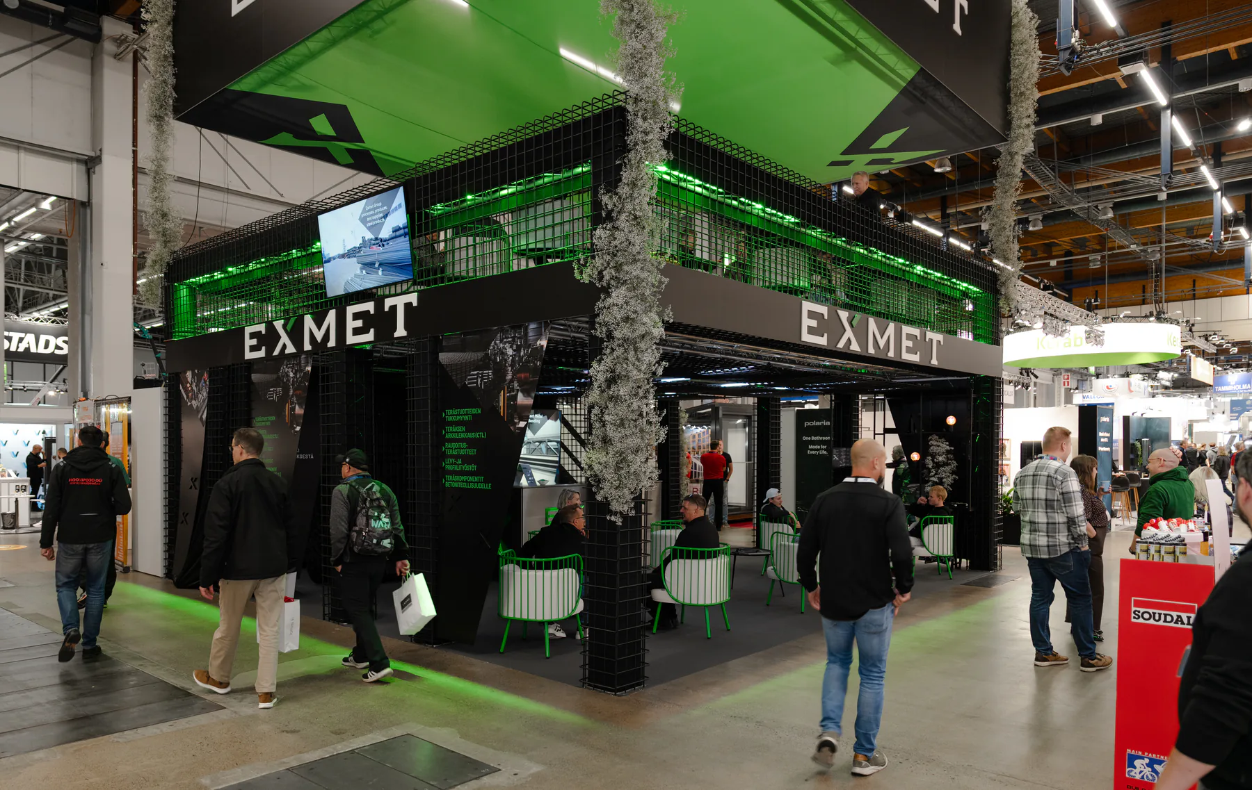 Two-level Exmet stand seen from the busy exhibition aisle