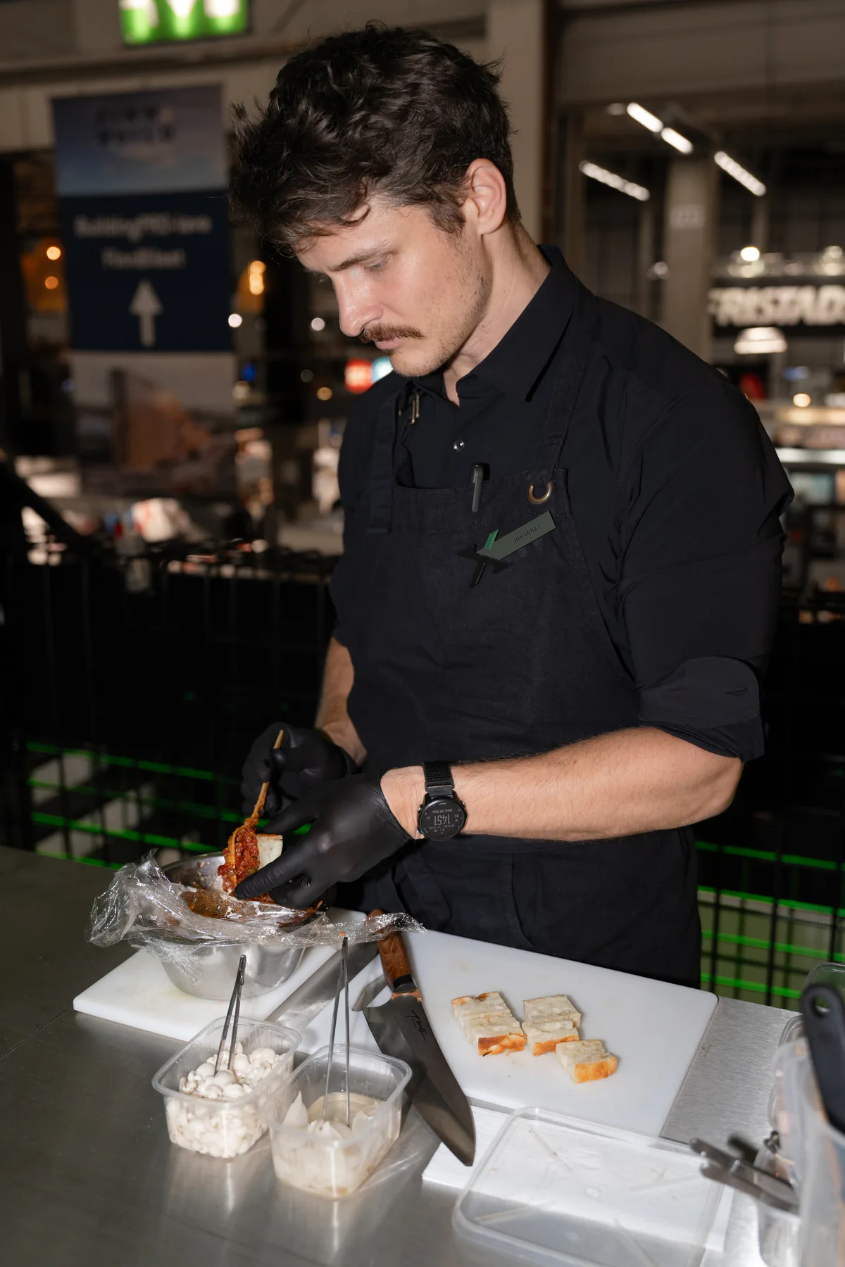 Chef plating food at the stand